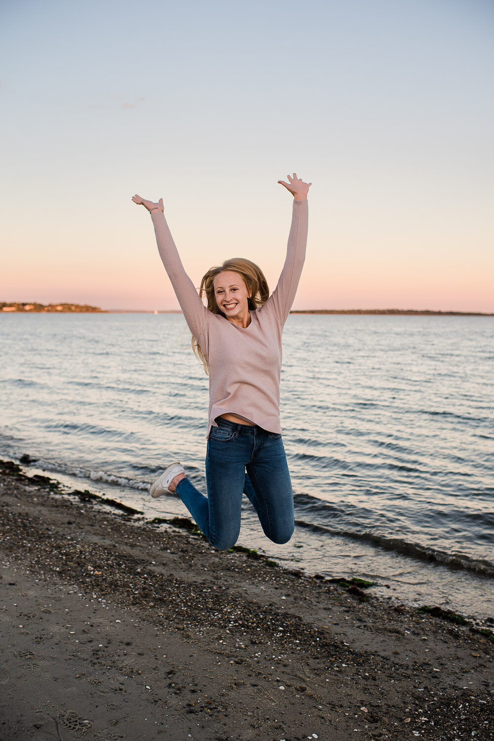 senior girl jumping on beach