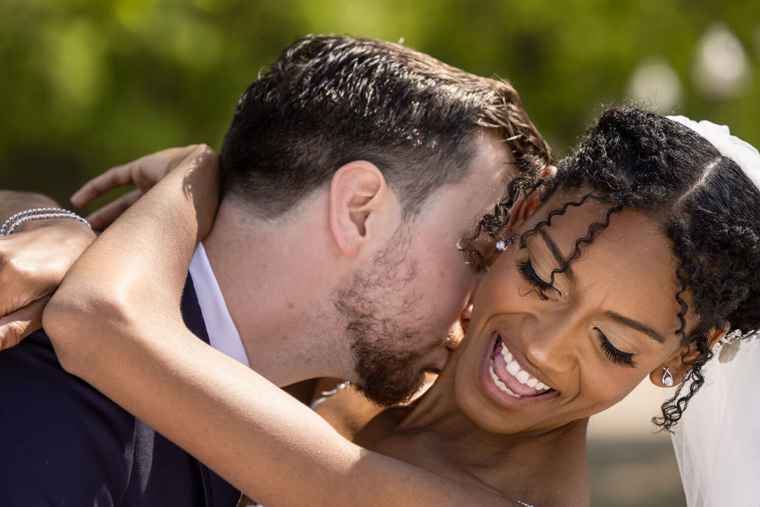 Groom kissing the neck of her bride