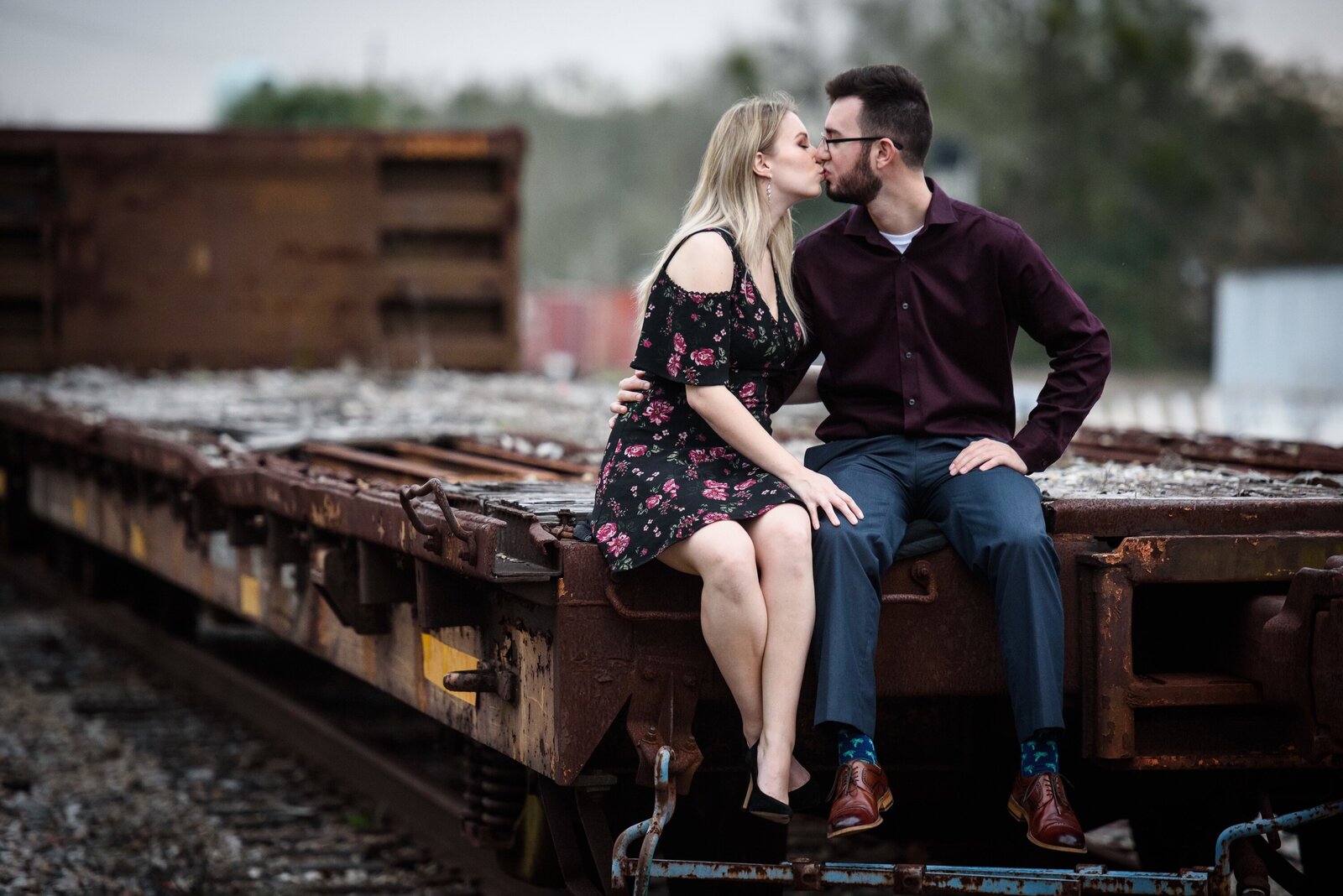 Couple sitting on old rail car in Bay St. Louis Mississippi