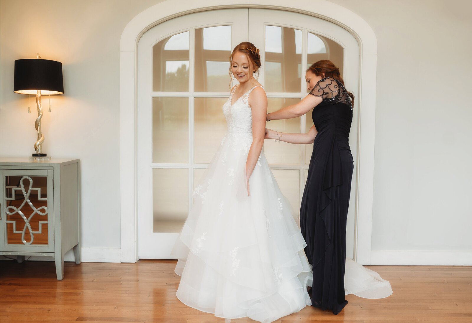 Bride prepares for her wedding day with her mother in the bridal suit at Chestnut Ridge Events in Asheville, NC