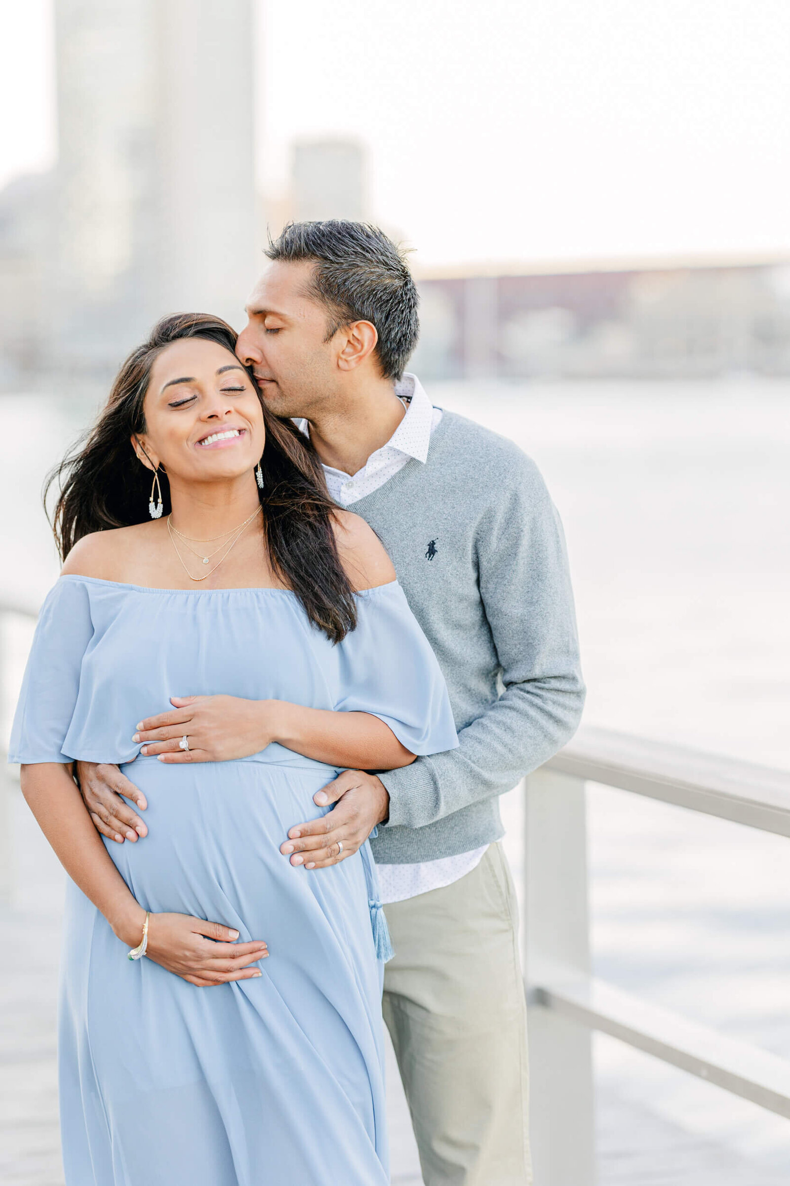 Man kisses pregnant wife's temple