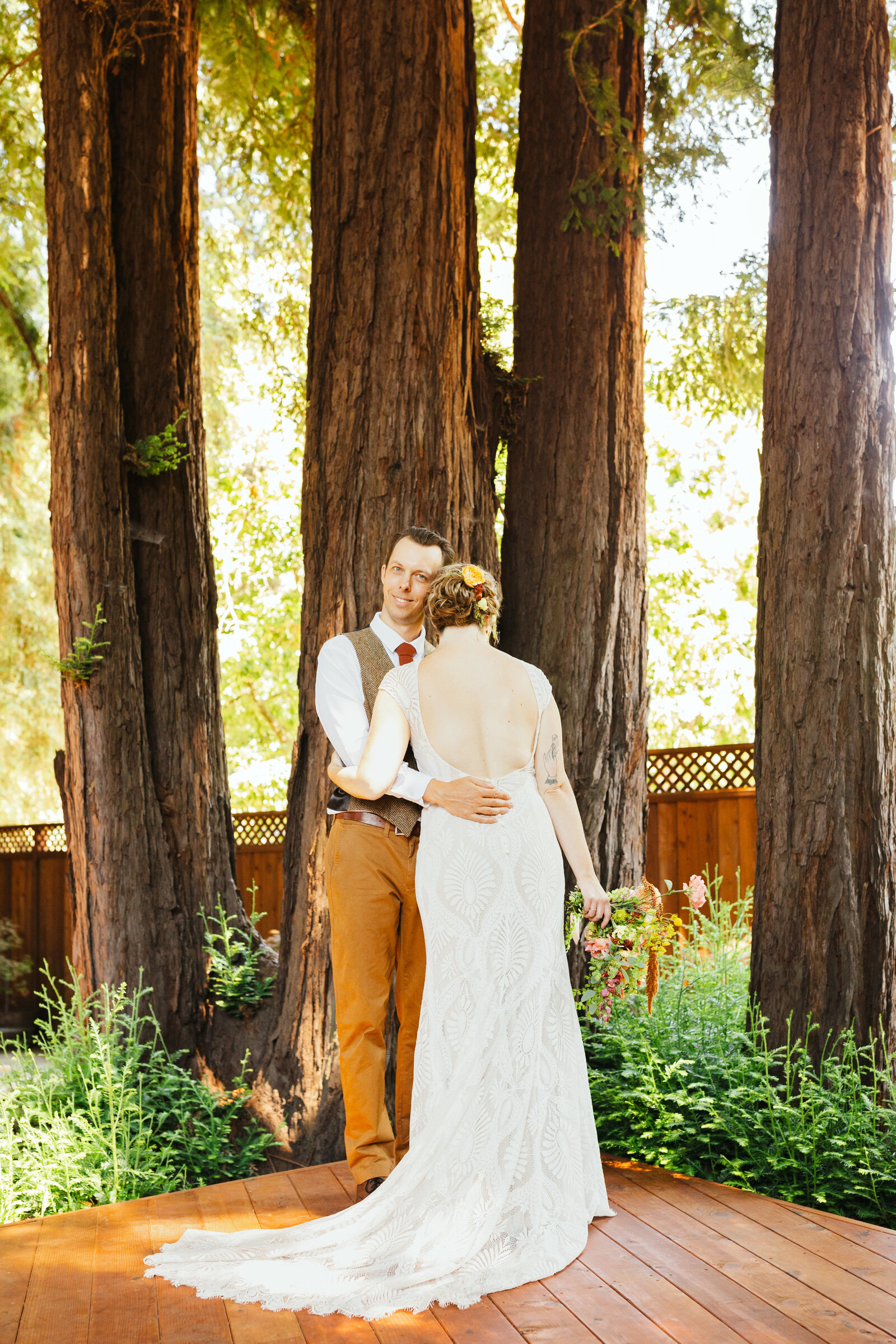Bride and groom on their colorful wedding day in Santa Cruz, California in the redwood trees.