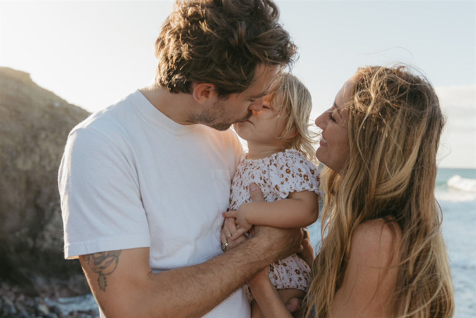 Editorial-style family beach portraits in Maui, showcasing coordinated outfits and natural ocean light.