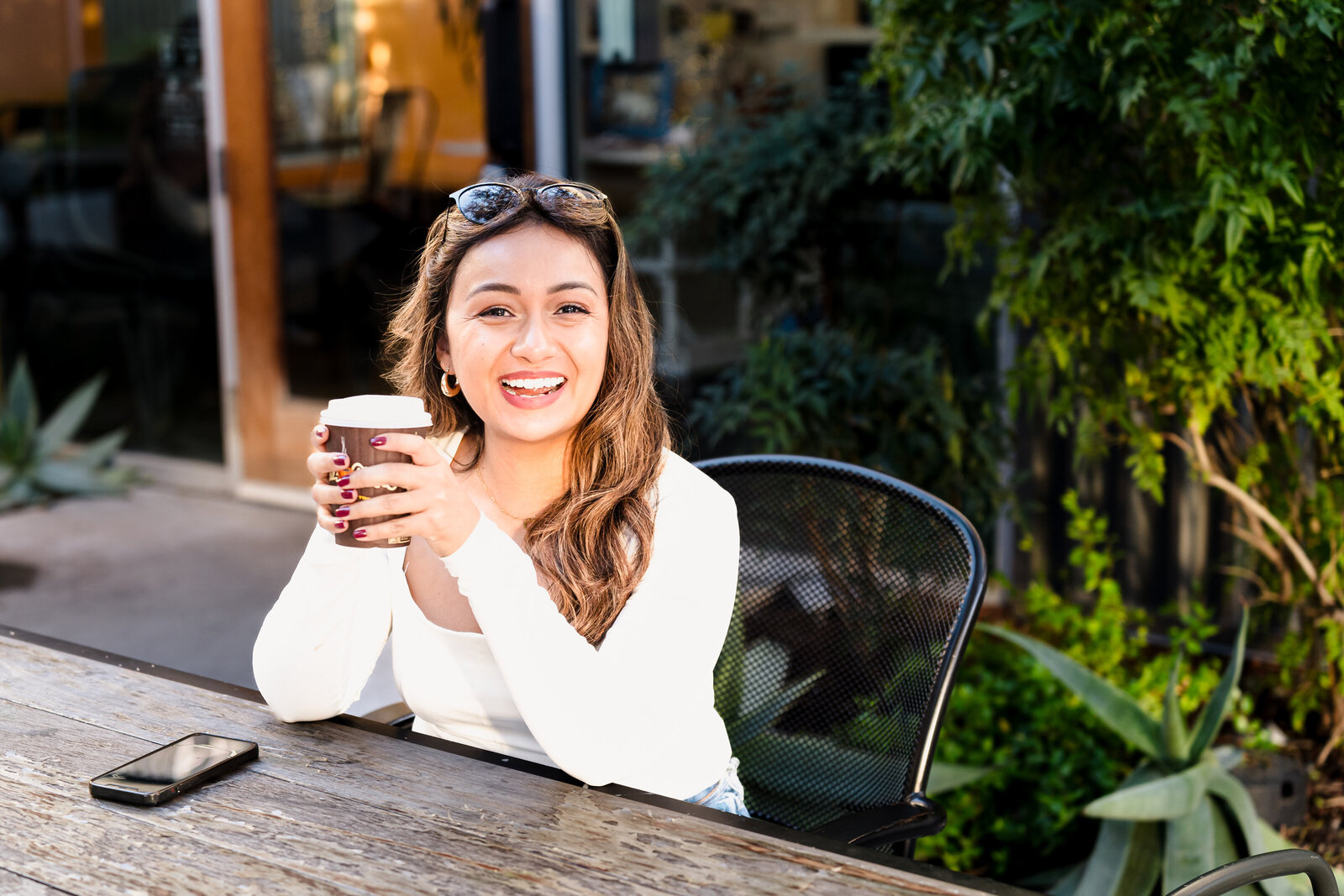 life coach holds a cup of coffee to showcase her lifestyle