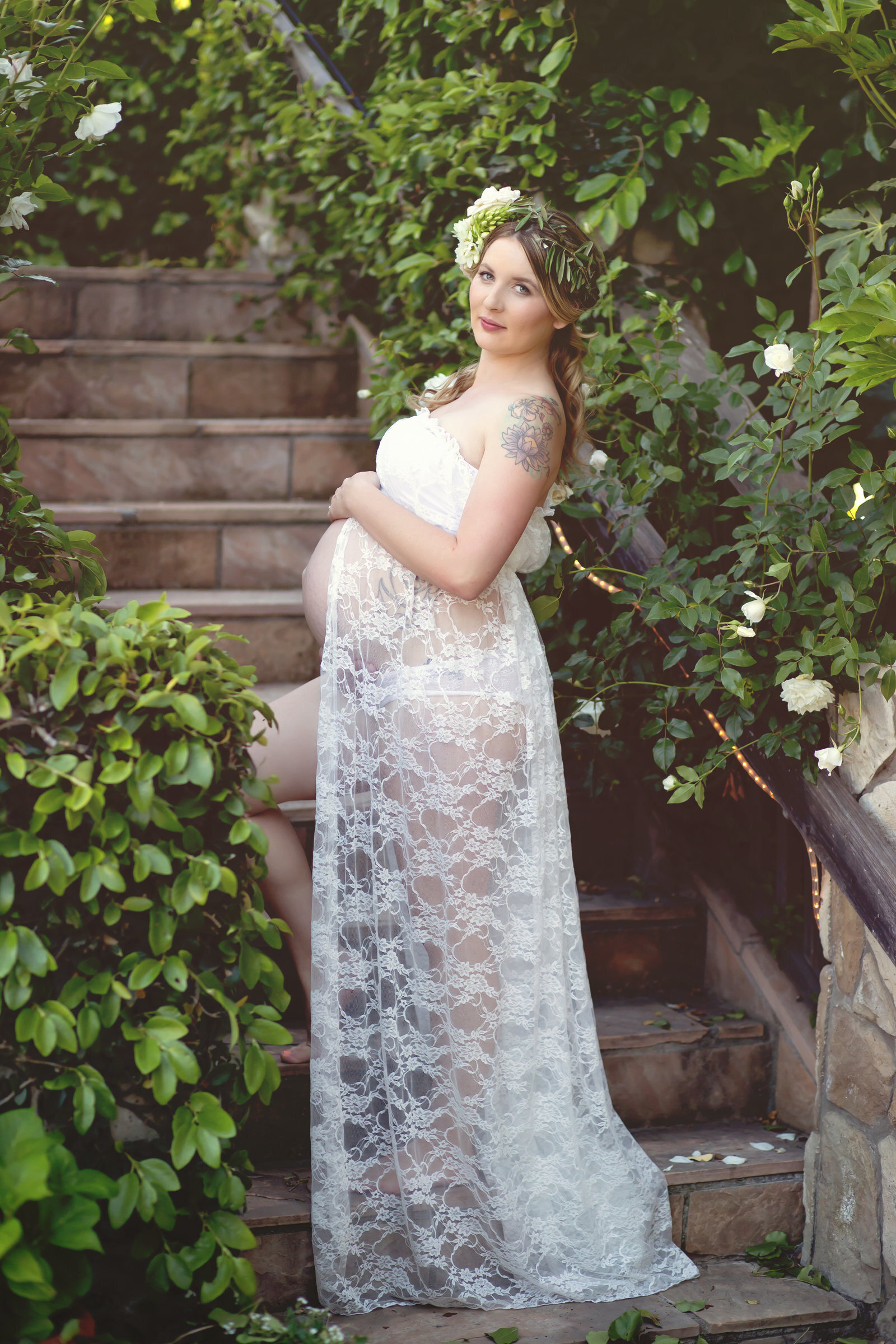 Woman in white lace gown outside