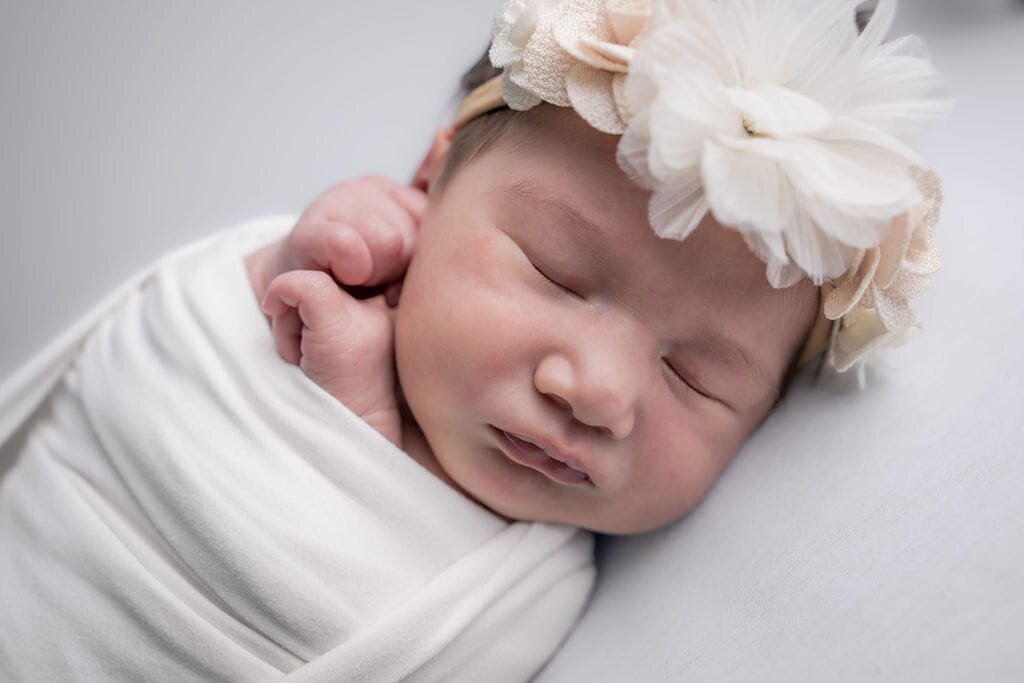 sweet baby girl sleeps soundly at her newborn photography session