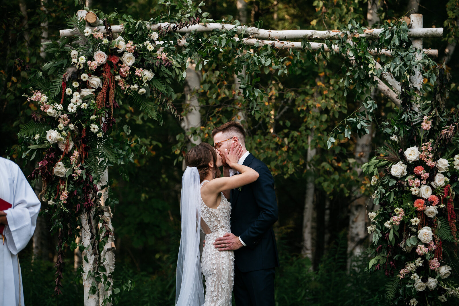 bride-groom-ceremony-kiss-alter-arch