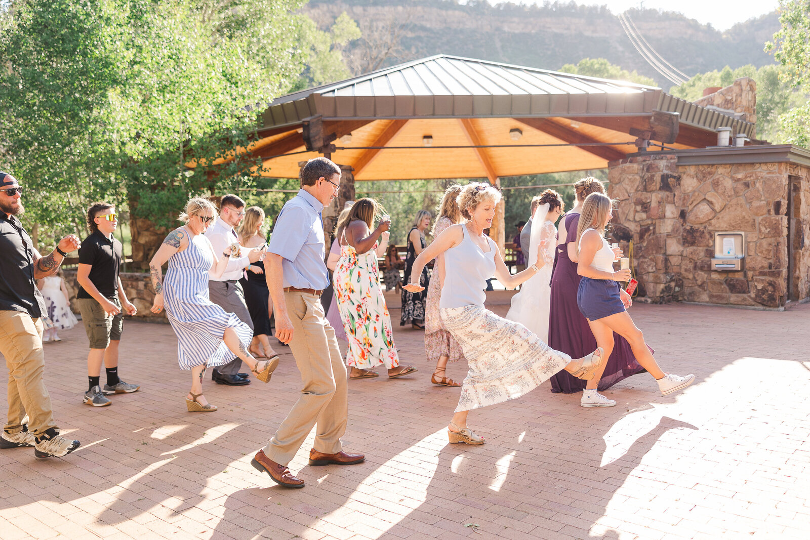 Wedding guests filling the dance floor, celebrating and dancing at a lively Ridgway State Park wedding reception