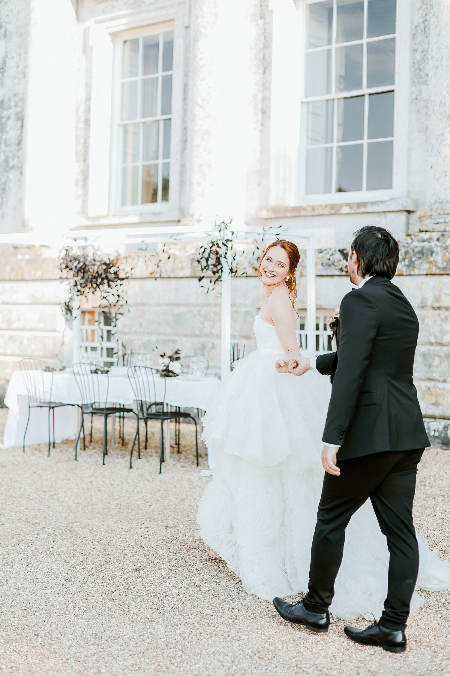 Came-House-wedding-venue-Dorset-bride-and-groom-walking-to-table