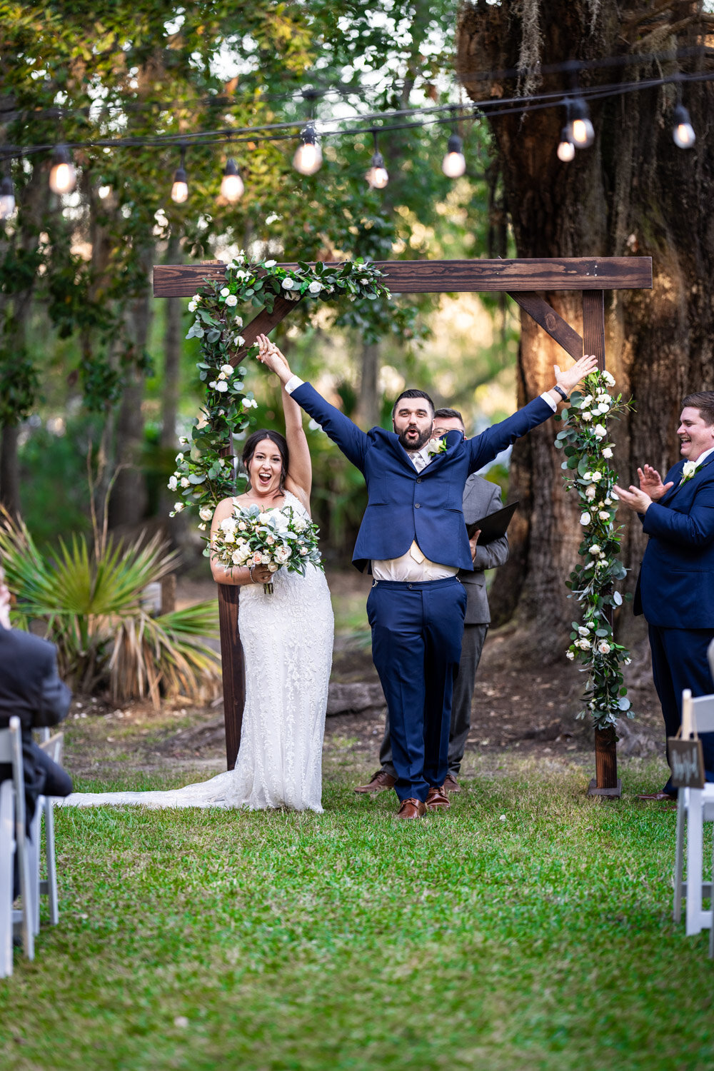 Bride and groom celebrate their wedding ceremony at Palmettos on the Bayou in Slidell