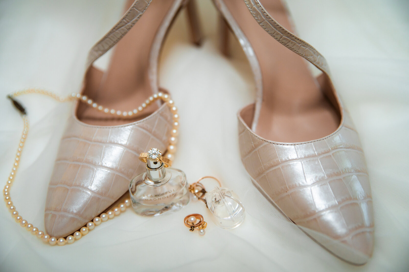 bride accessories on her jackson hole wedding day wiht shoes, earrings, and rings