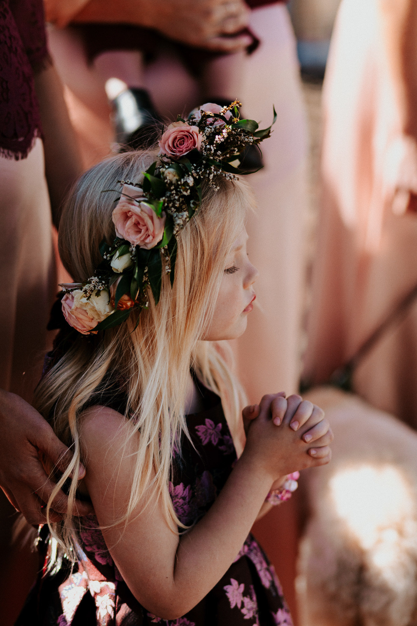 cutest photo of flower girl praying at a wedding in denver.