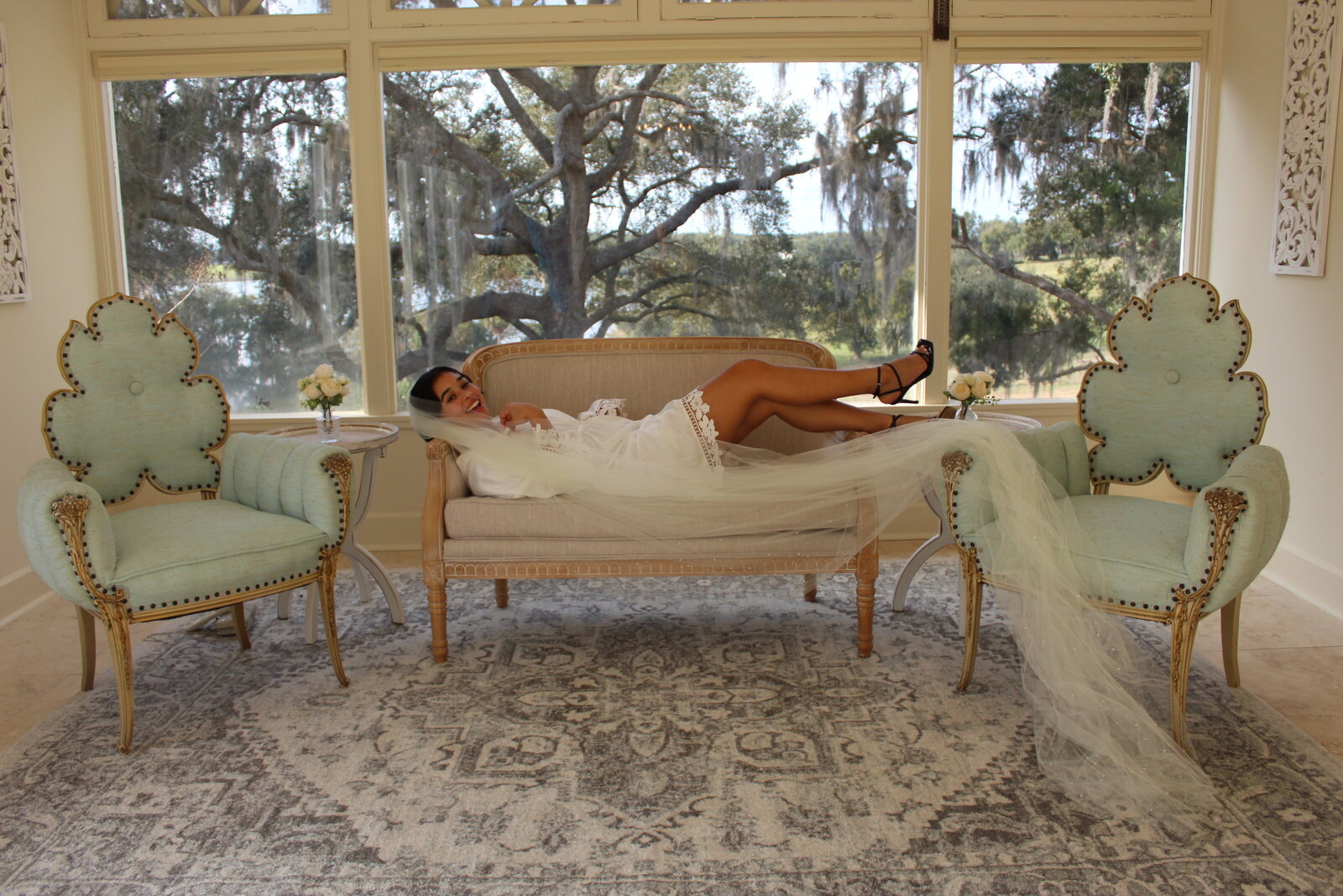 Bride laying on sofa in bridal suite