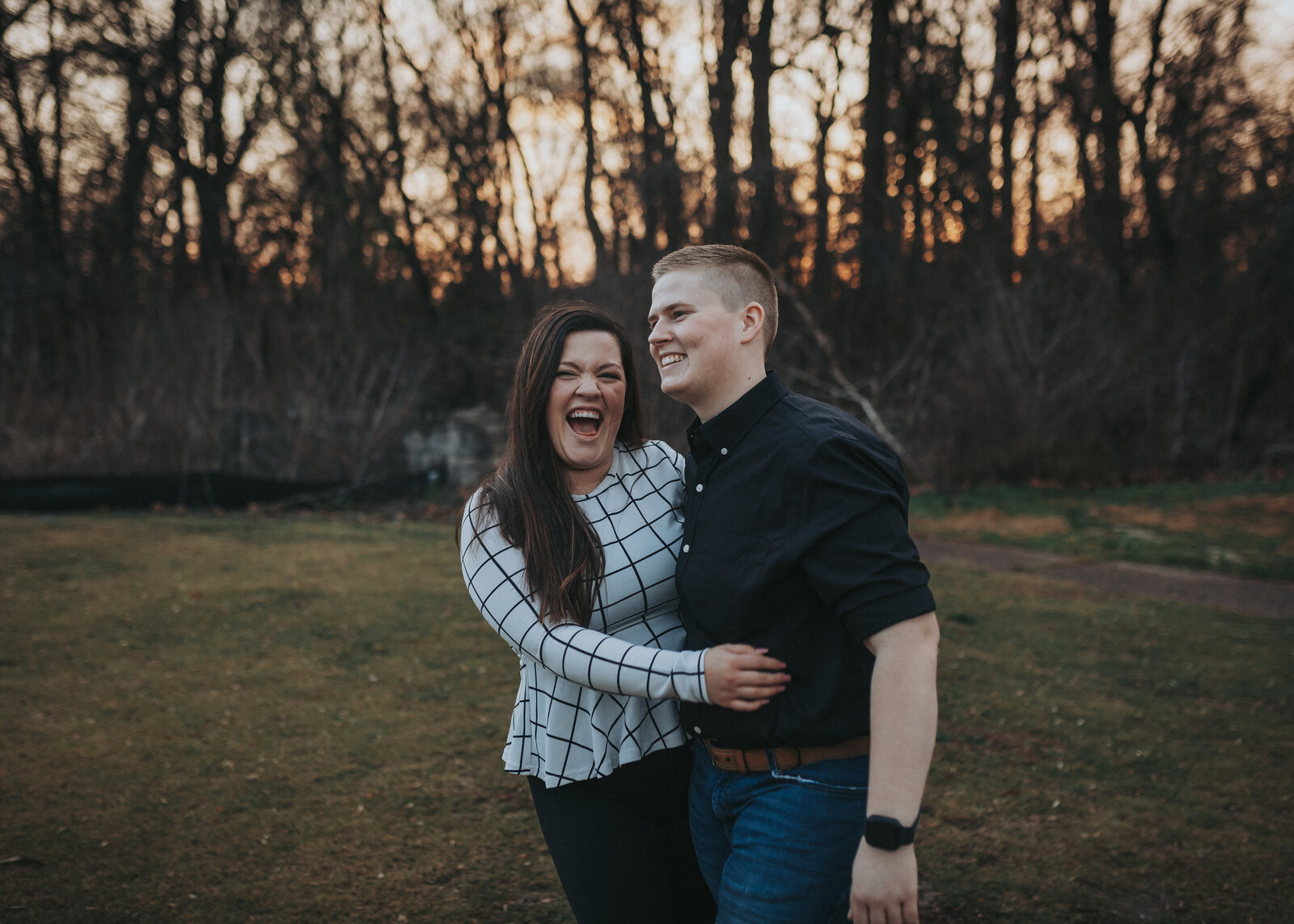 LGBTQ couple laughs together while walking through Overton Park