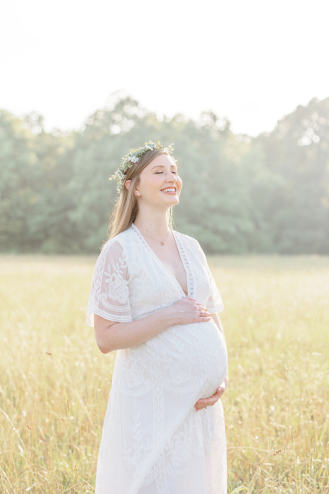 mom happy in the middle of a field during Leesburg, Virginia maternity picture