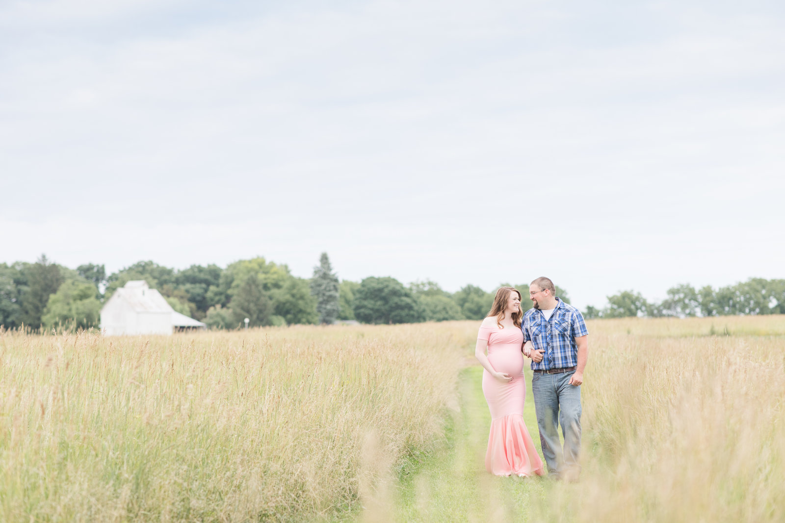maternity-mom-dad-walking-in-field-decatur