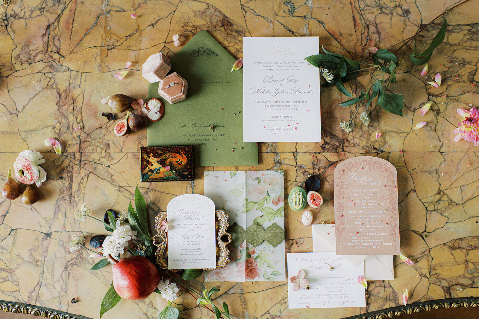 Wedding details photo of invitation, rings and florals