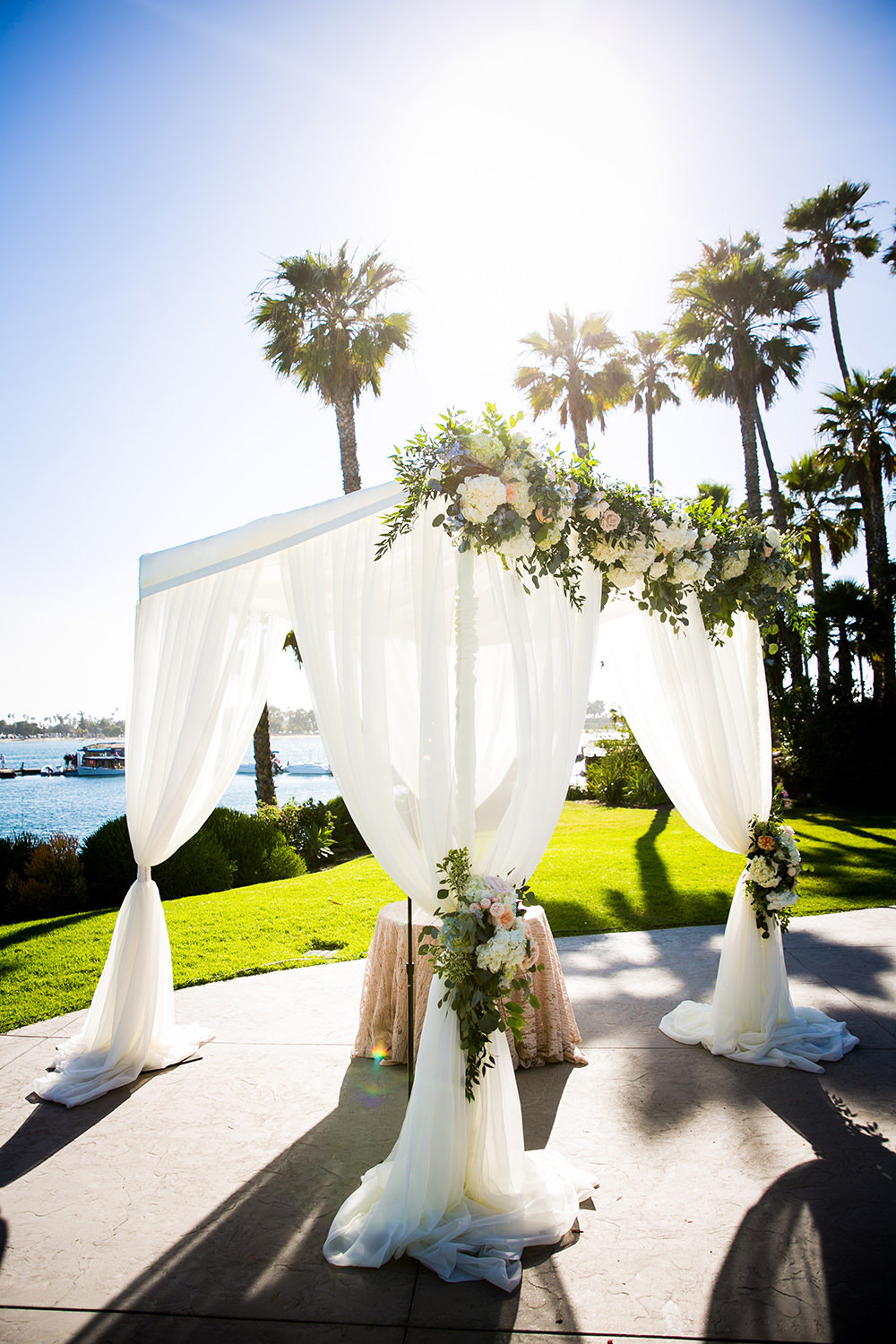 ceremony arch with flowers and ocean view