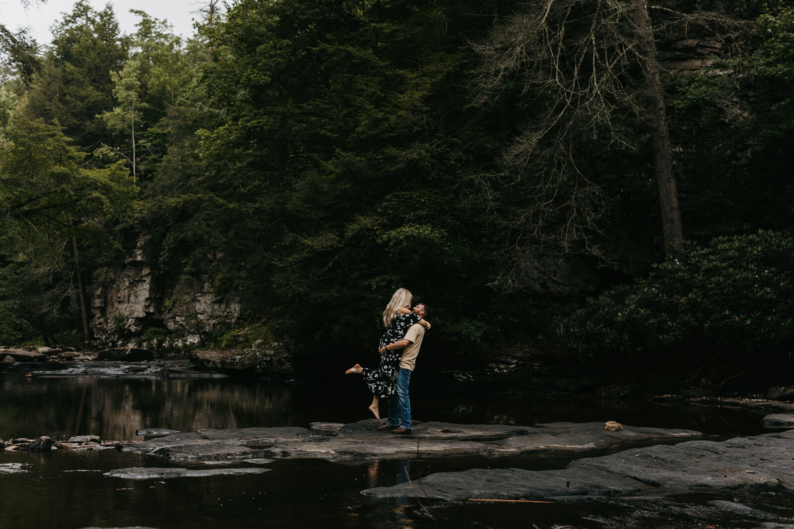 Couple Kissing on Rock in the woods