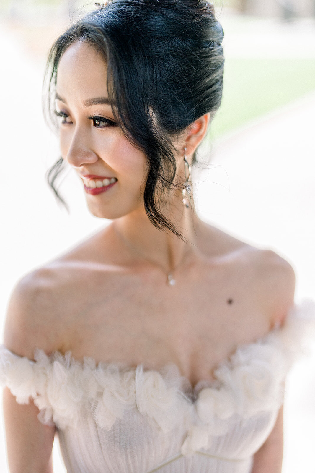 The bride, glowing with happiness, poses beautifully on her wedding day at Stanford Memorial Church.
