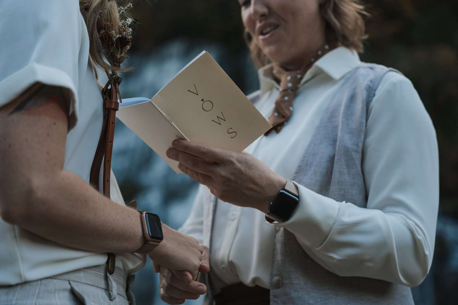 Woman reads vows to her wife in front of a Tennessee Waterfall