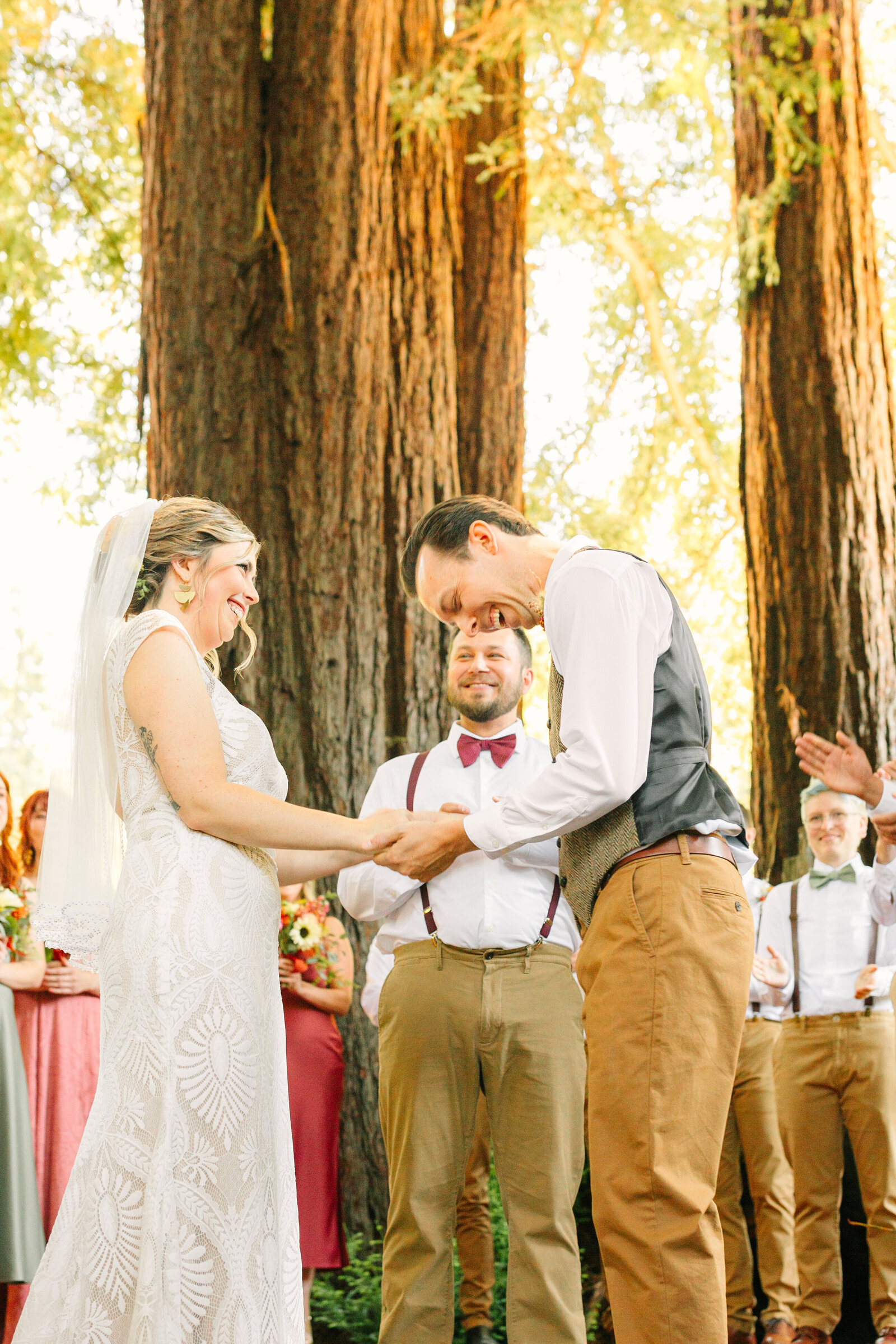Bride and groom at their colorful wedding ceremony in Santa Cruz, California in the redwood trees.
