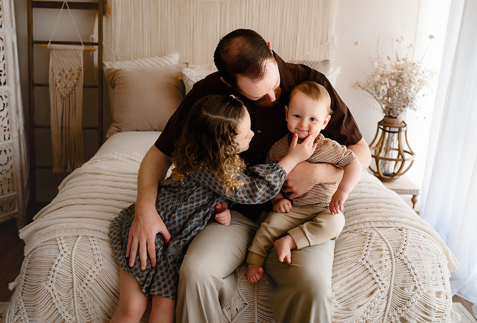 That smile of baby brother as big sister squeezes his sweet cheek. The connection with families is the best and at Paula Goforth Photography we focus on those connections