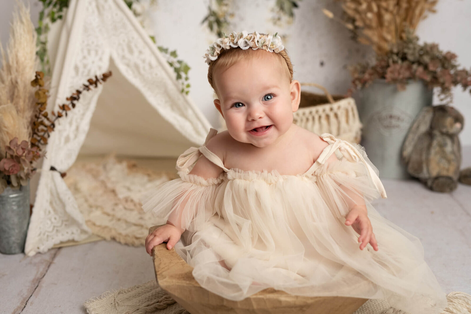 8 month old girl with tulle dress and wooden bowl