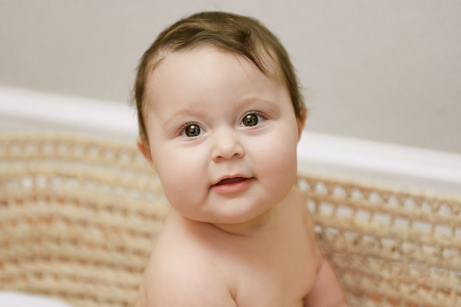 smiling baby girl in a moses basket by york pa photographer