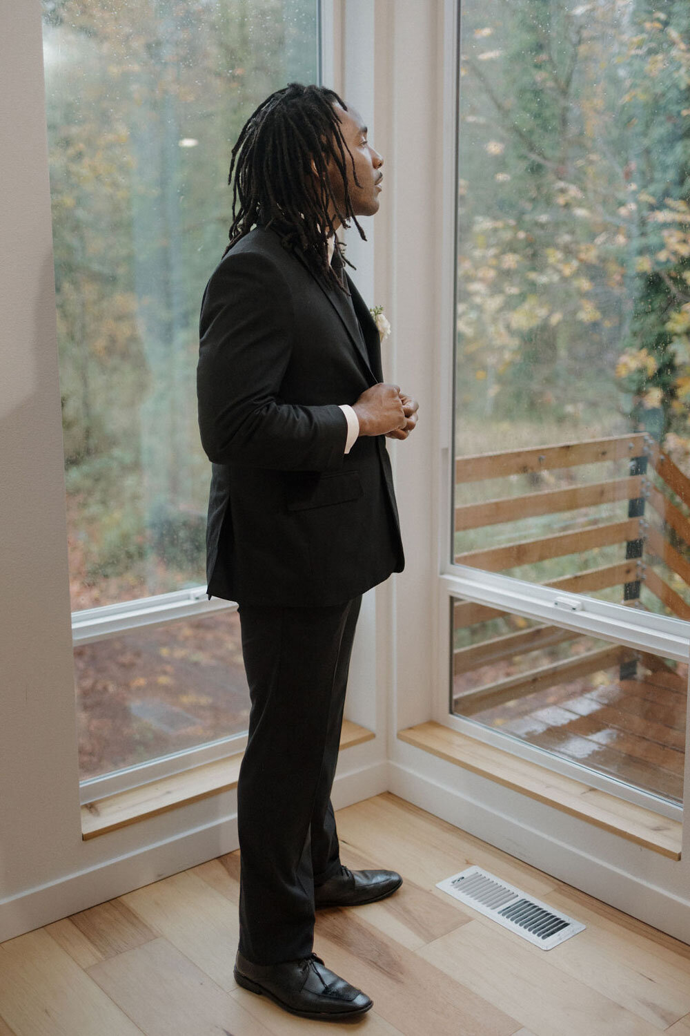 Groom fixing his suit indoors