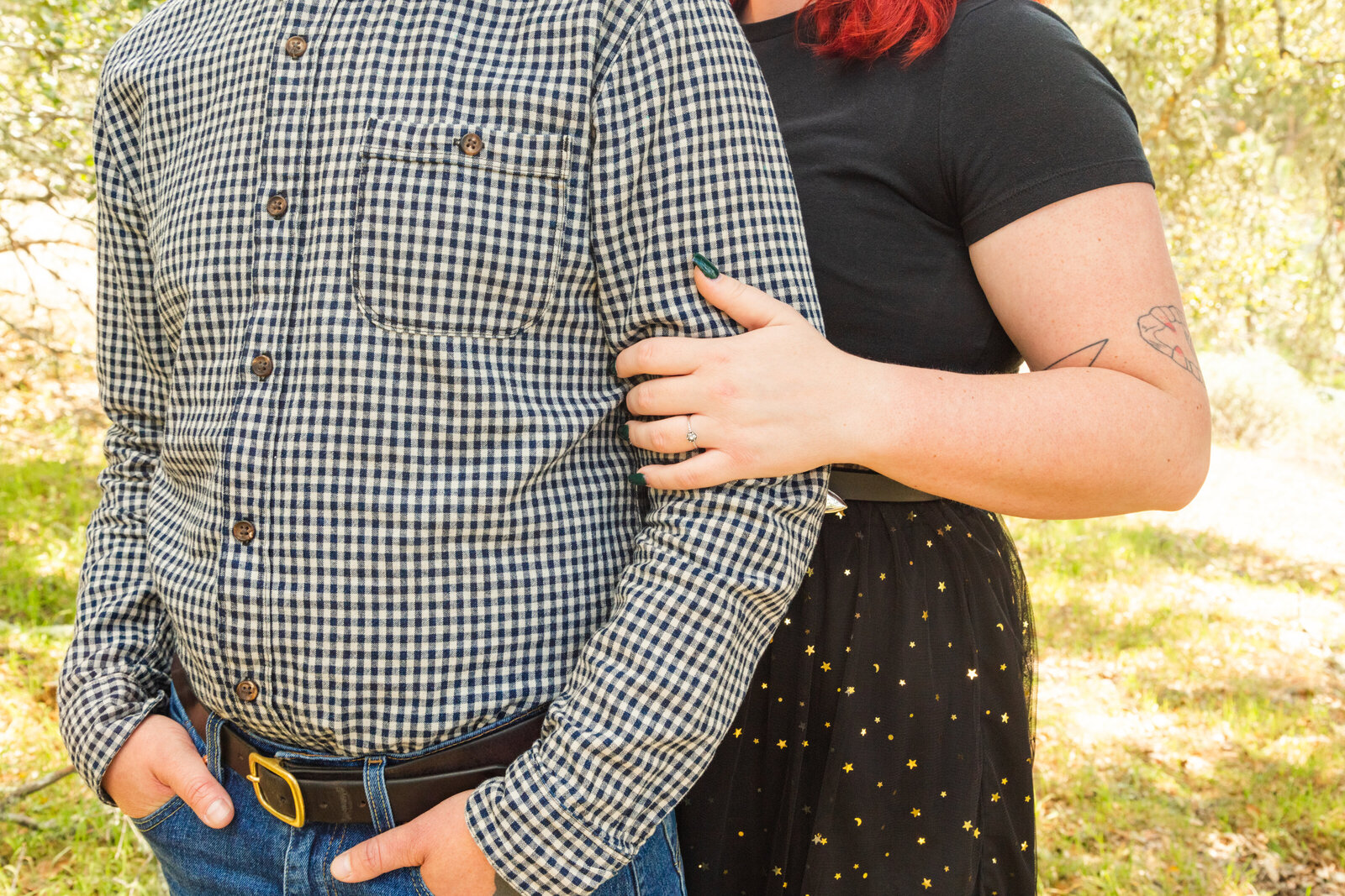 An tattooed engaged couple poses for photos in a redwood forest in Santa Cruz, Ca.