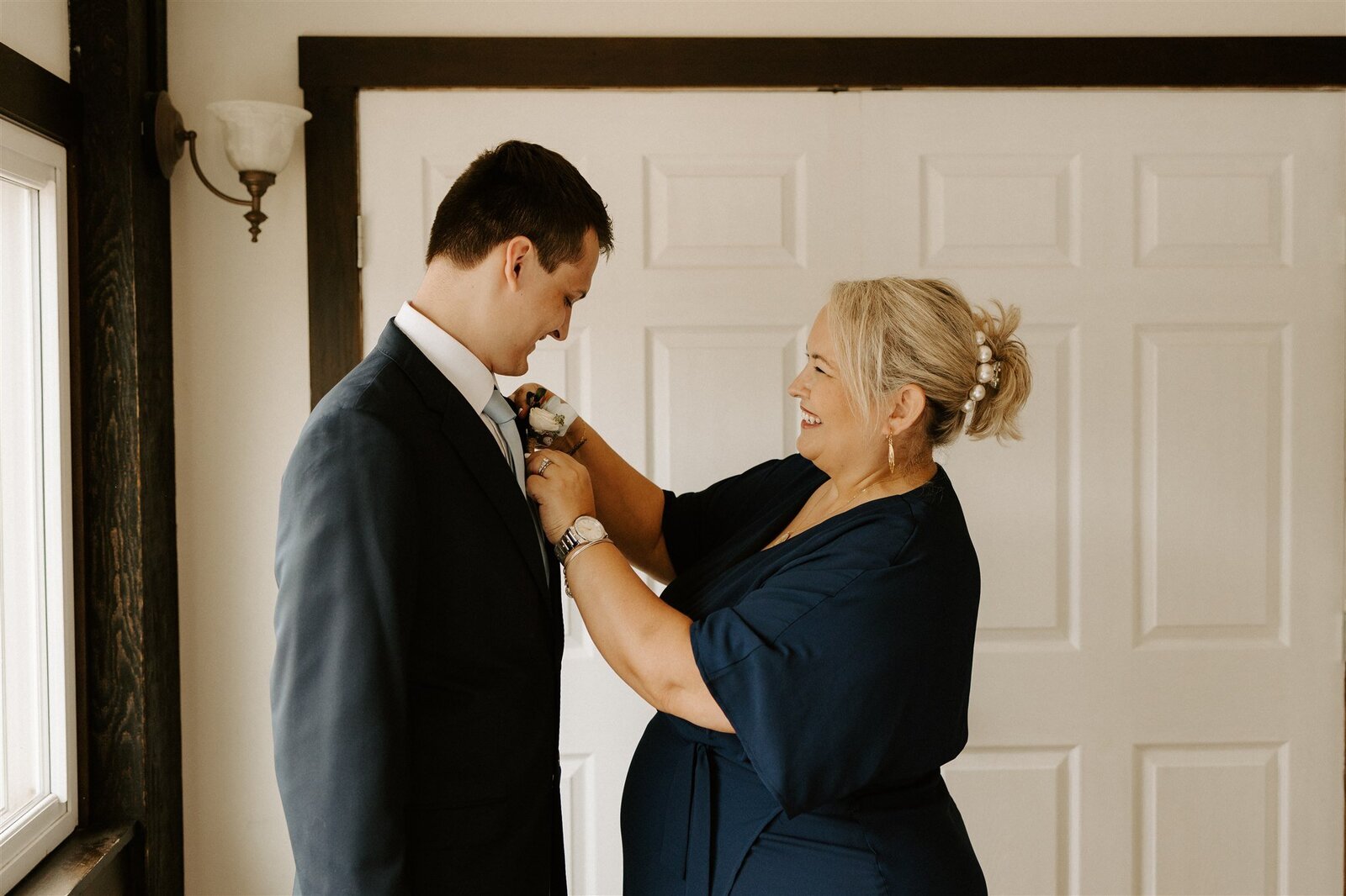 groom and mom floral smiling