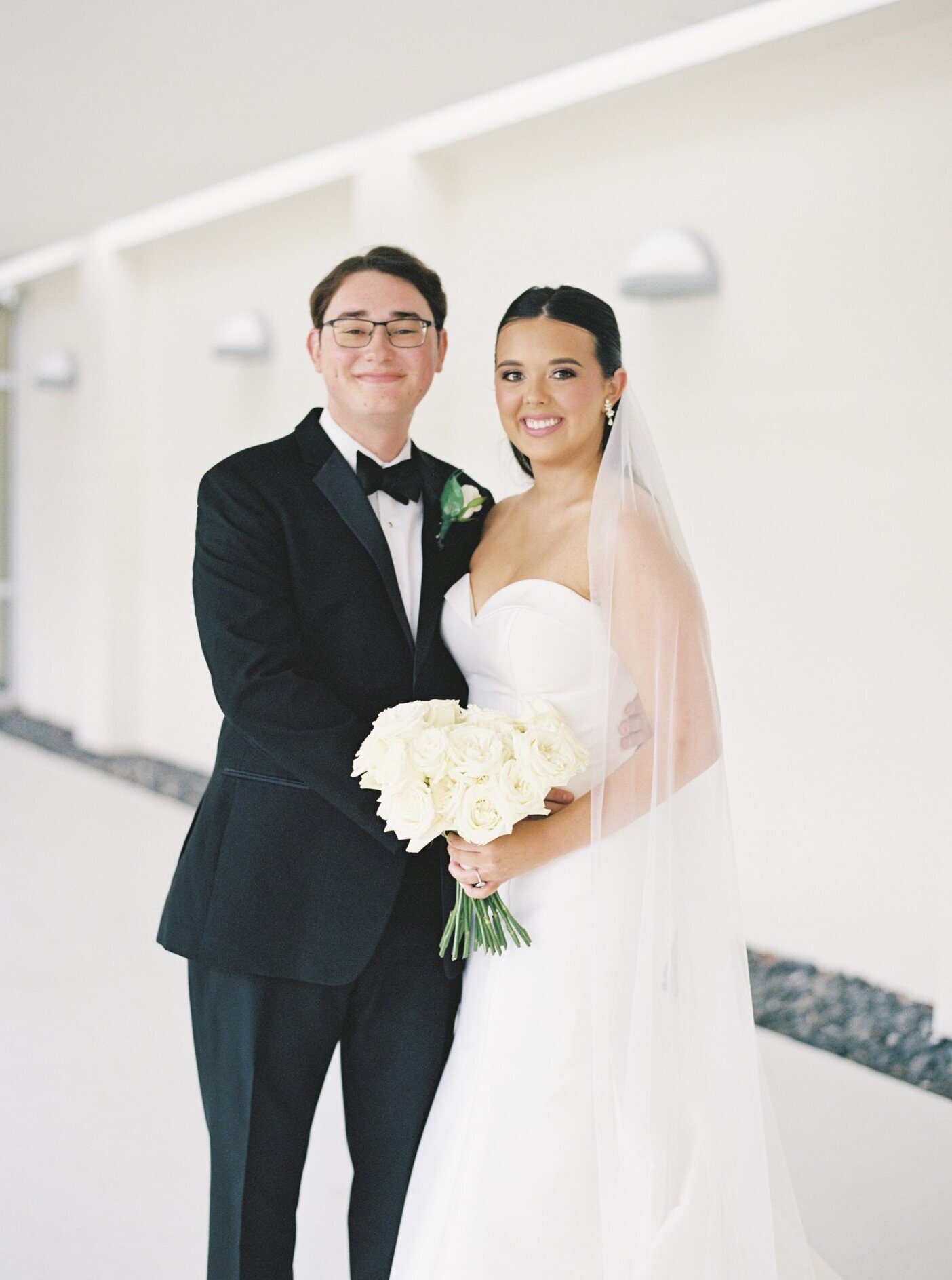 Bride and groom captured in a timeless, elegant moment on their wedding day, photographed on film by Morgan Alysse, Louisiana film photographer.