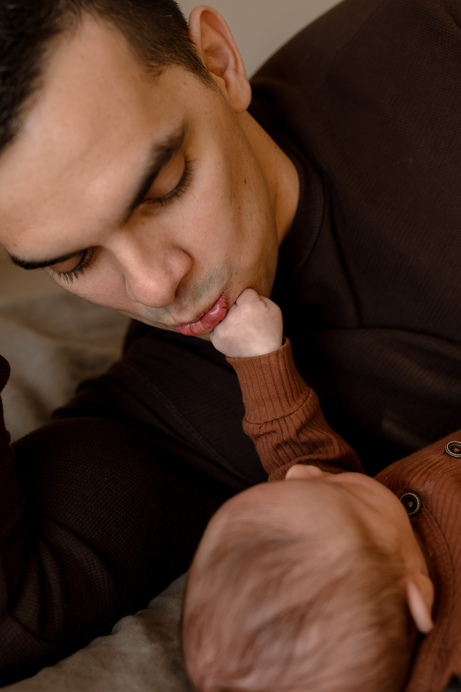 newborn touching dad's face