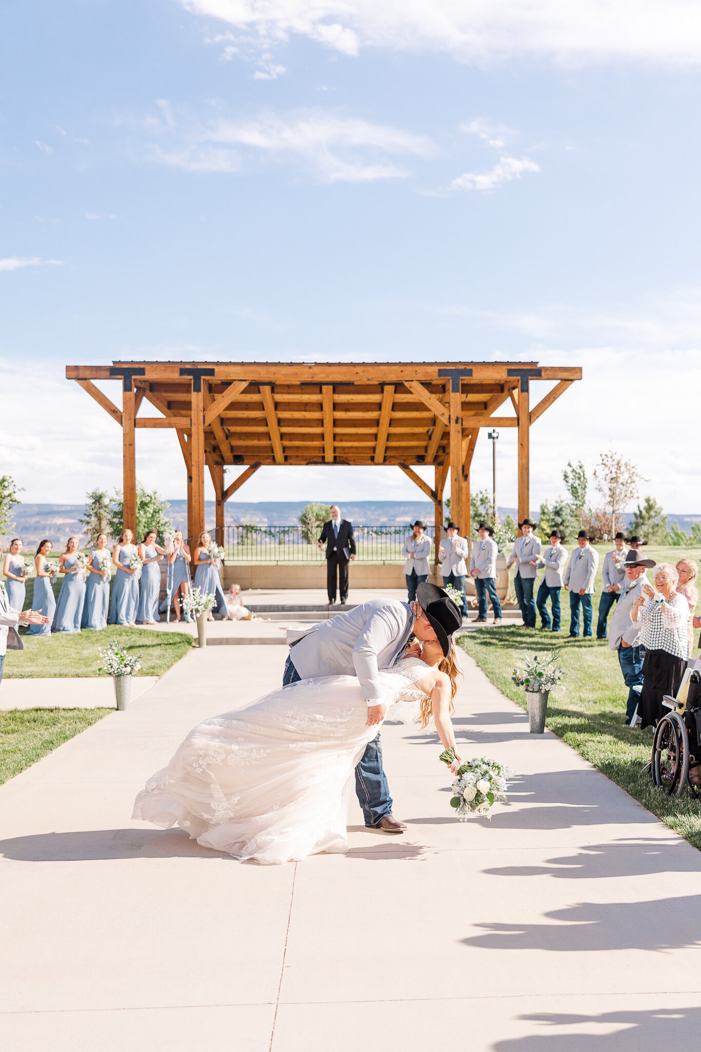 Groom dipping his bride for a kiss as they walk back down the aisle after saying 'I do' at Absolute Prestige in Loma