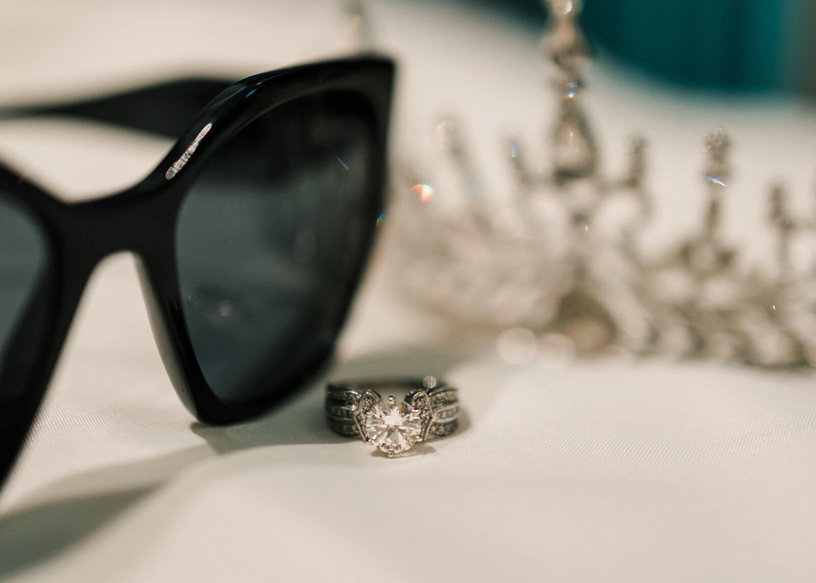 Sunglasses, wedding ring and crown