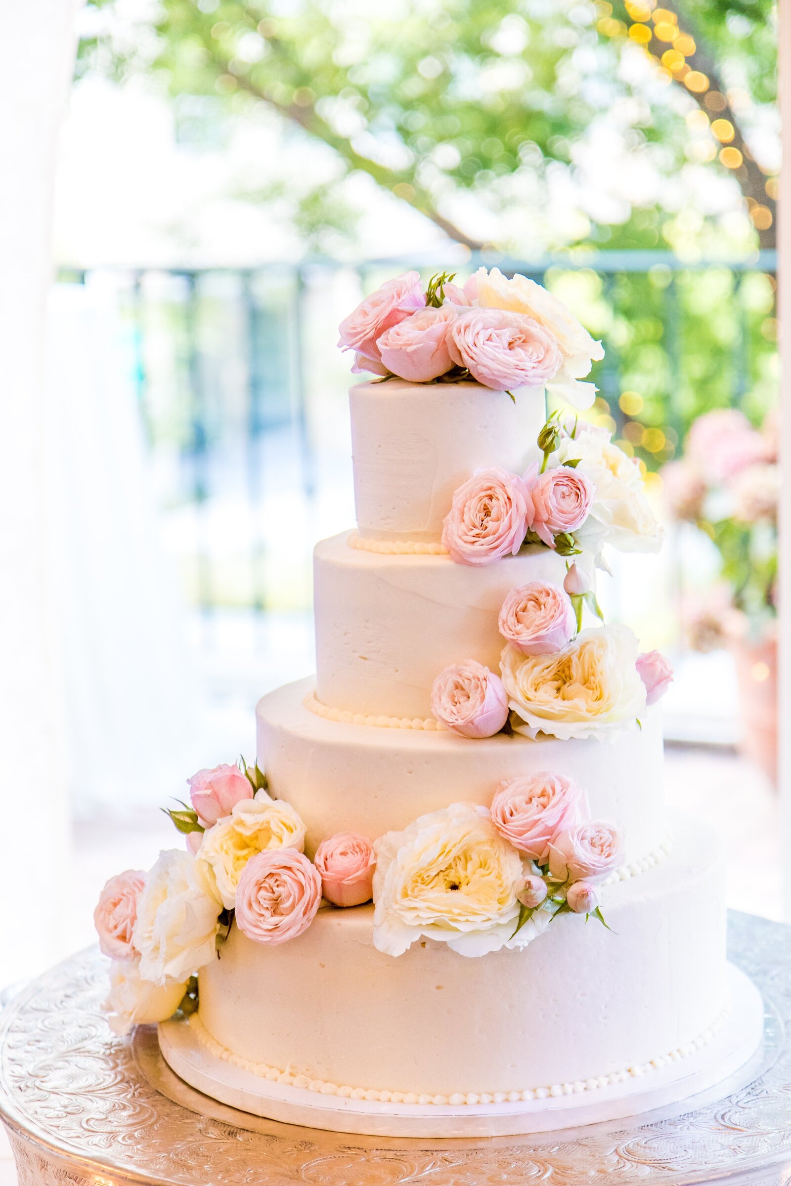 Elegant four tier pink wedding cake with floral details