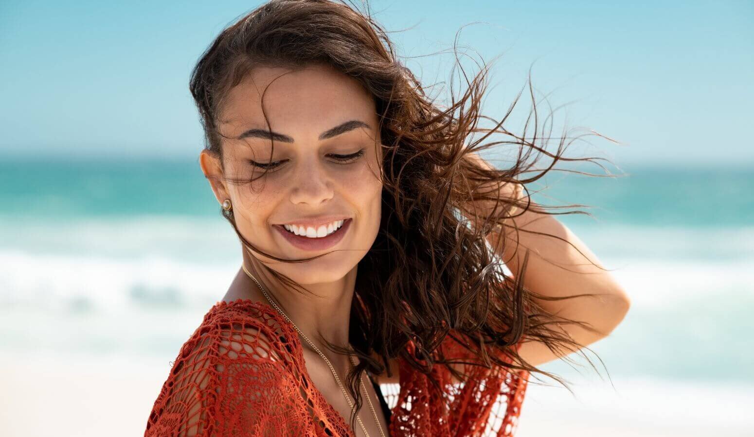 Midlife woman smiling at the beach