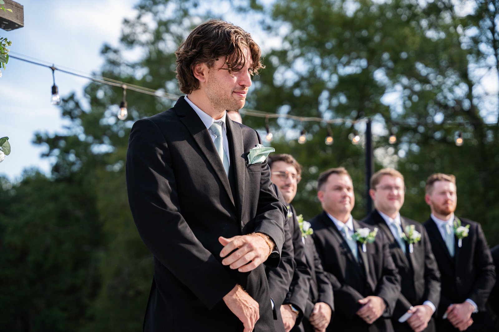 Zach tearing up as he sees his bride walking down the aisle at the wedding ceremony at the Venue Daisy Hill wedding venue in Georgia