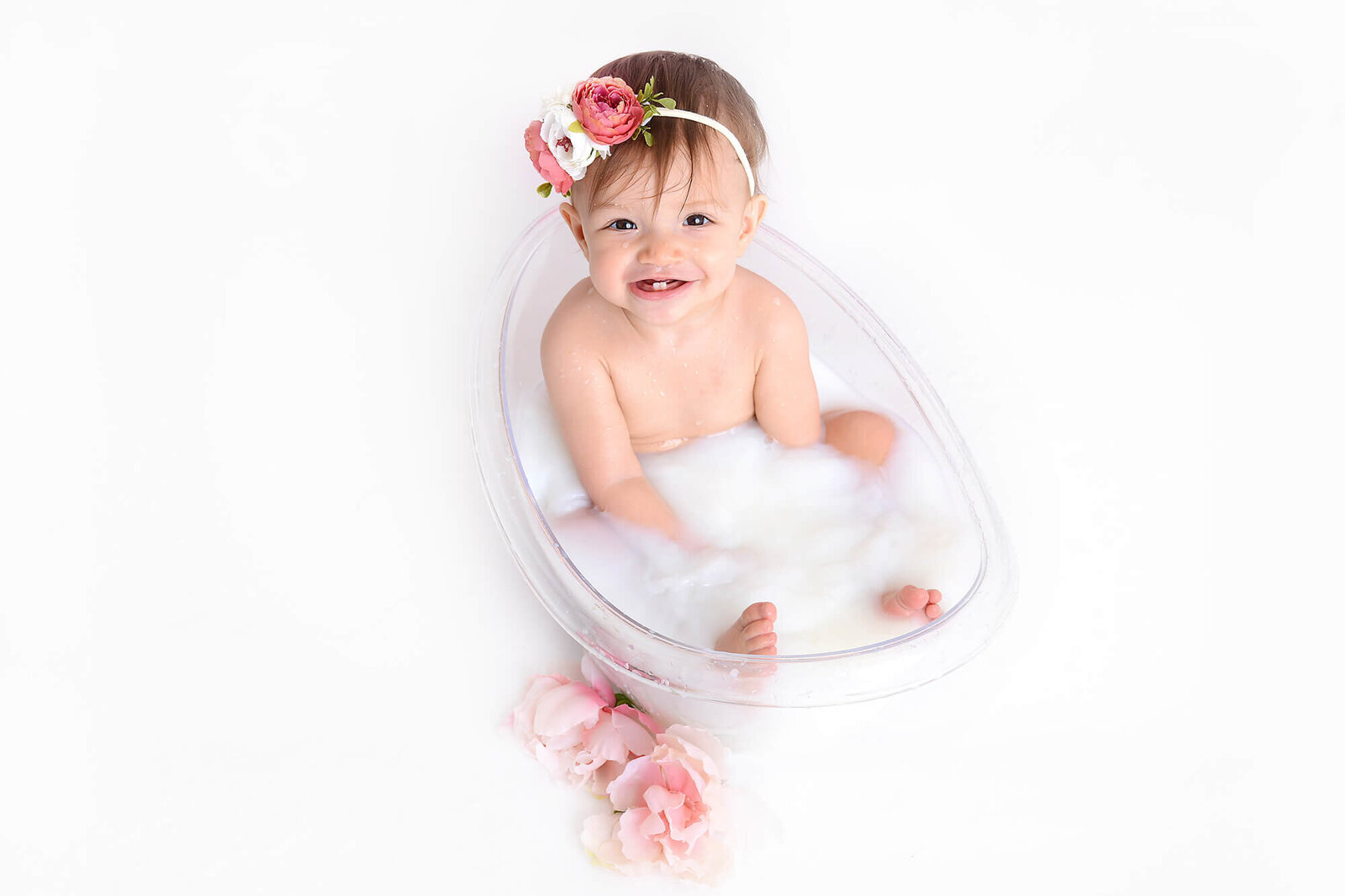 birthday girl smiles in a milk bath photoshoot