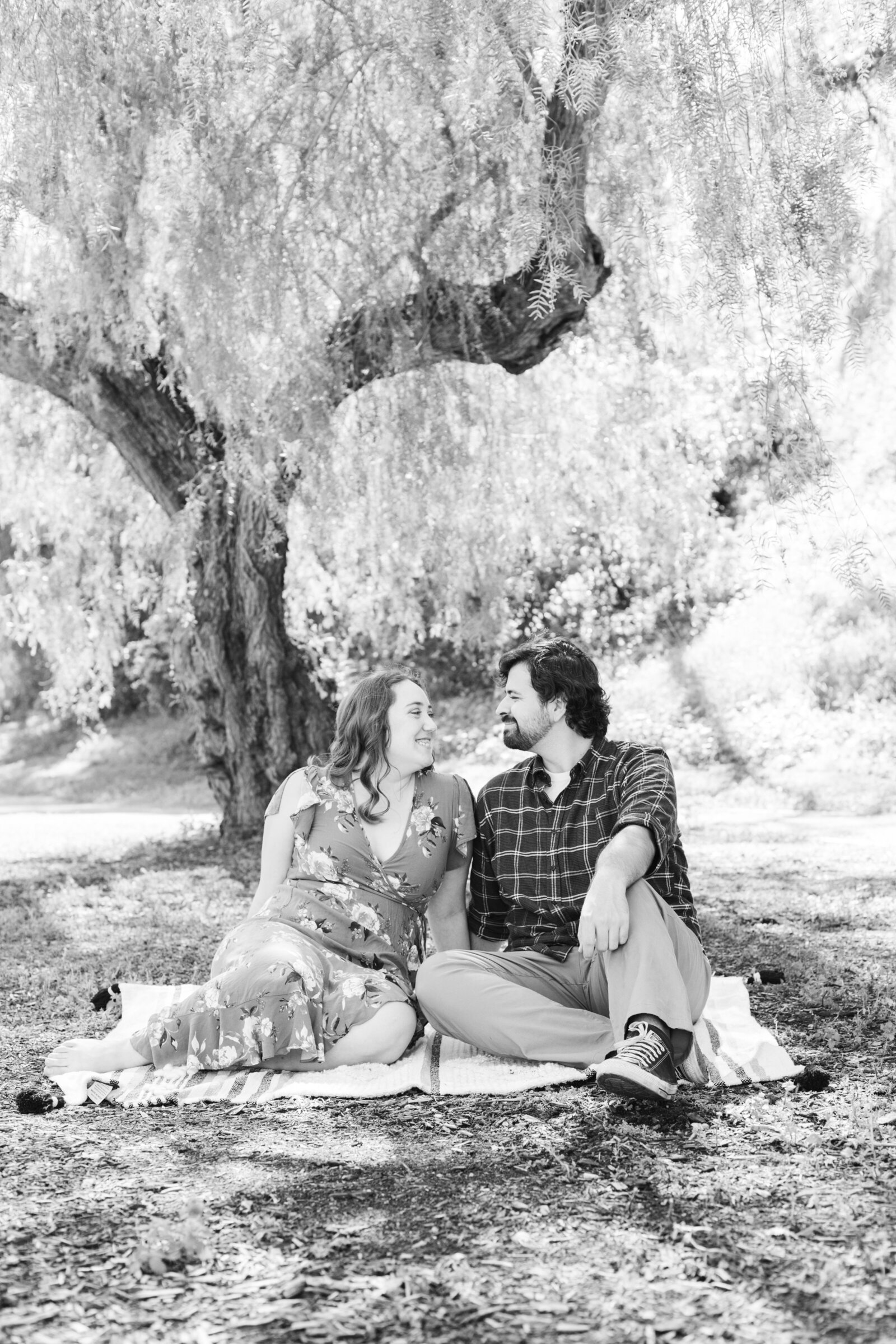 An engaged couple poses for photos in a garden in Los Angeles, Ca.