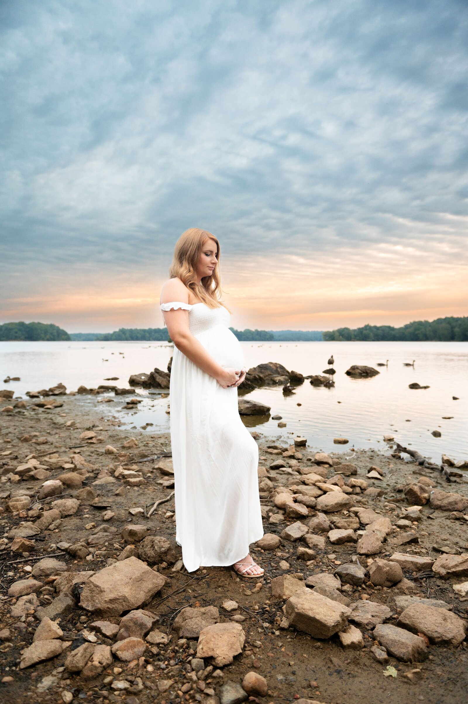 woman looking at the sunset over the water at loch raven reservoir