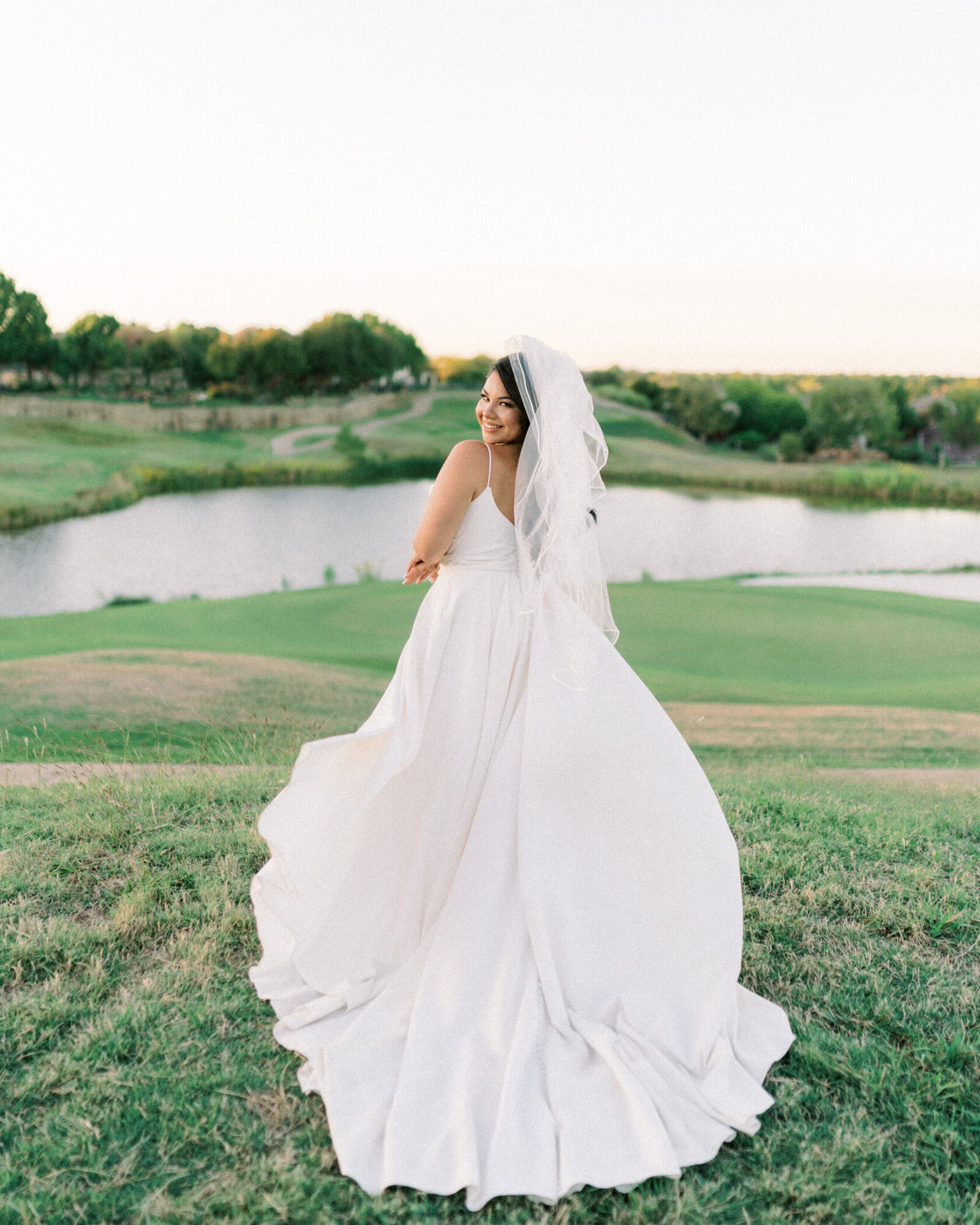 Fort Worth Texas Bride poses in her modern wedding gown  at Fossil Creek golf course