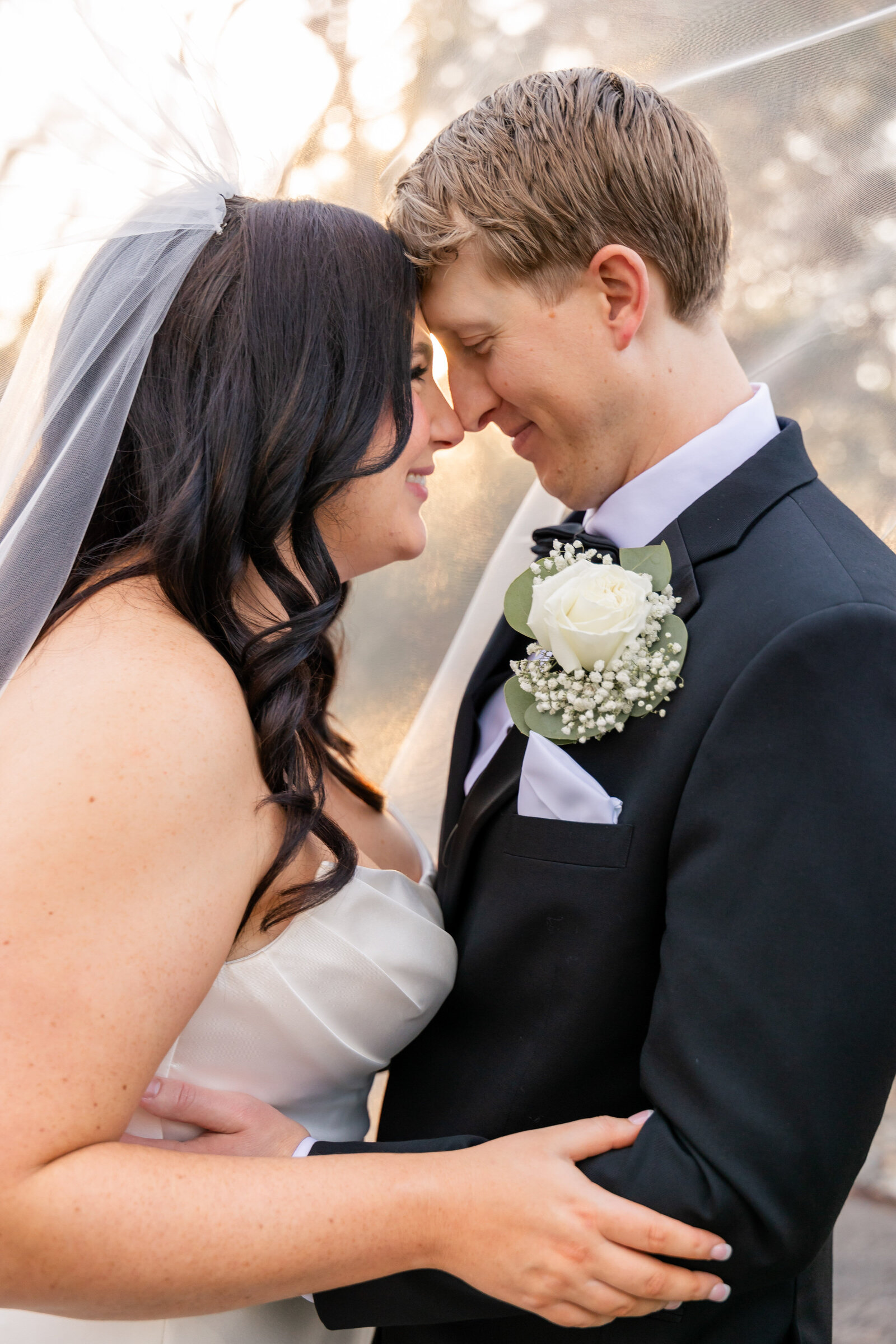 groom and bride snuggling