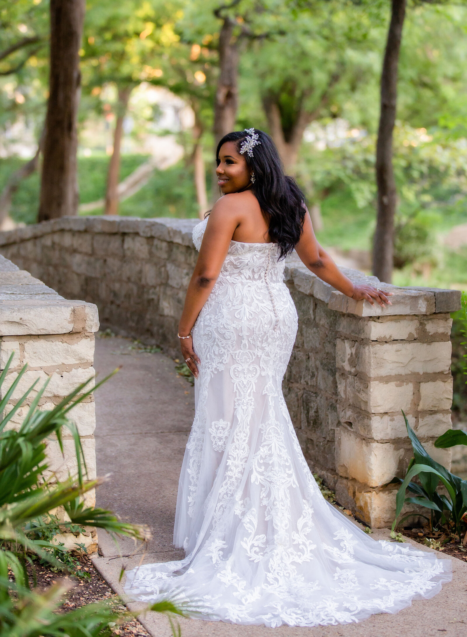 bride posing near a bridge