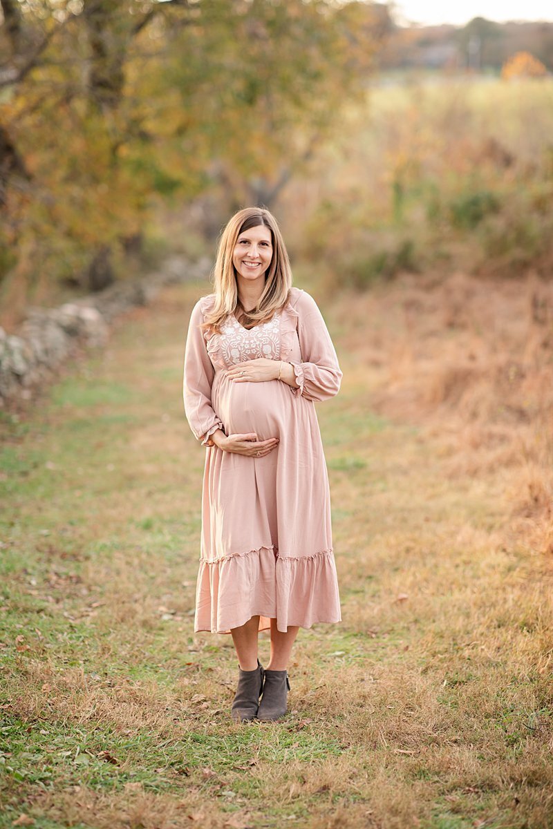 Pregnant woman in pink dress outdoors in a field by Maryland Maternity Photographer : Rebecca Leigh Photography