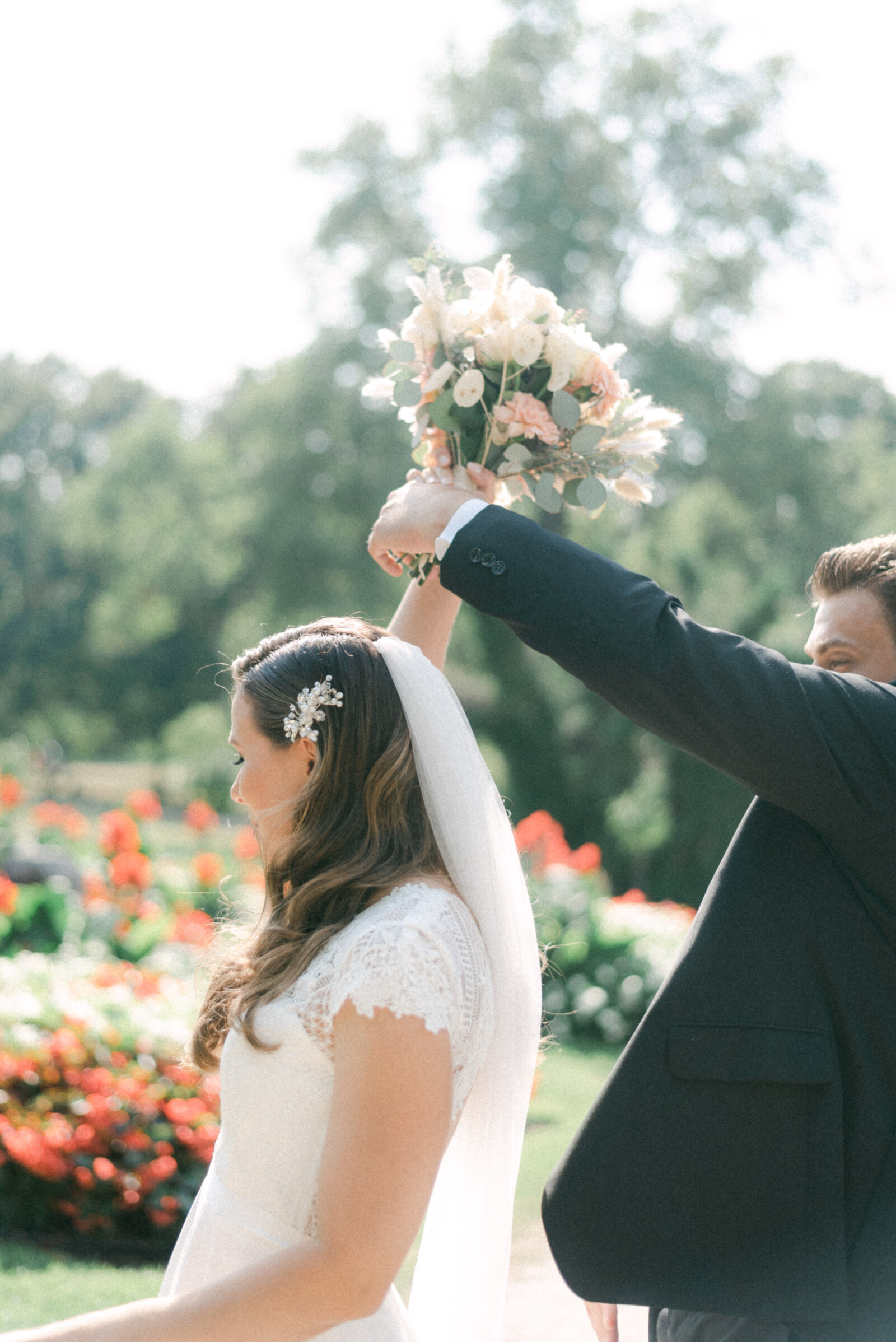 Bride and groom dancing and holding a bouquet during their wedding photography with elopement photographer Hannika Gabrielsson.