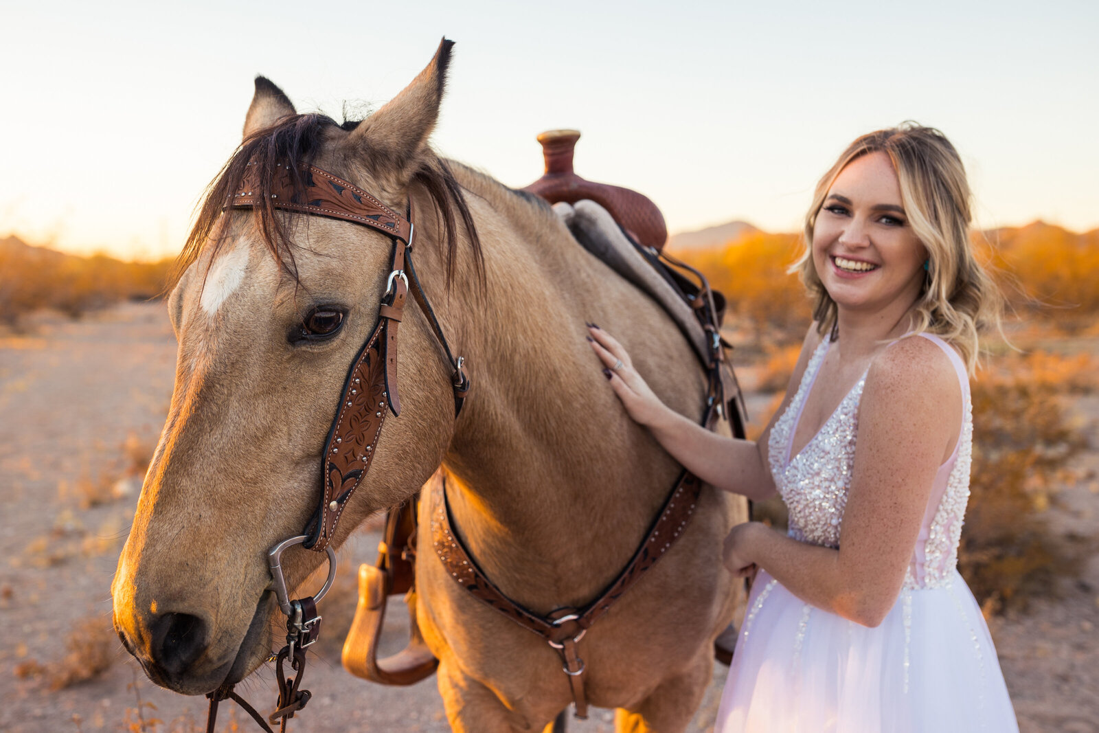 bride with her horse on her wedding day
