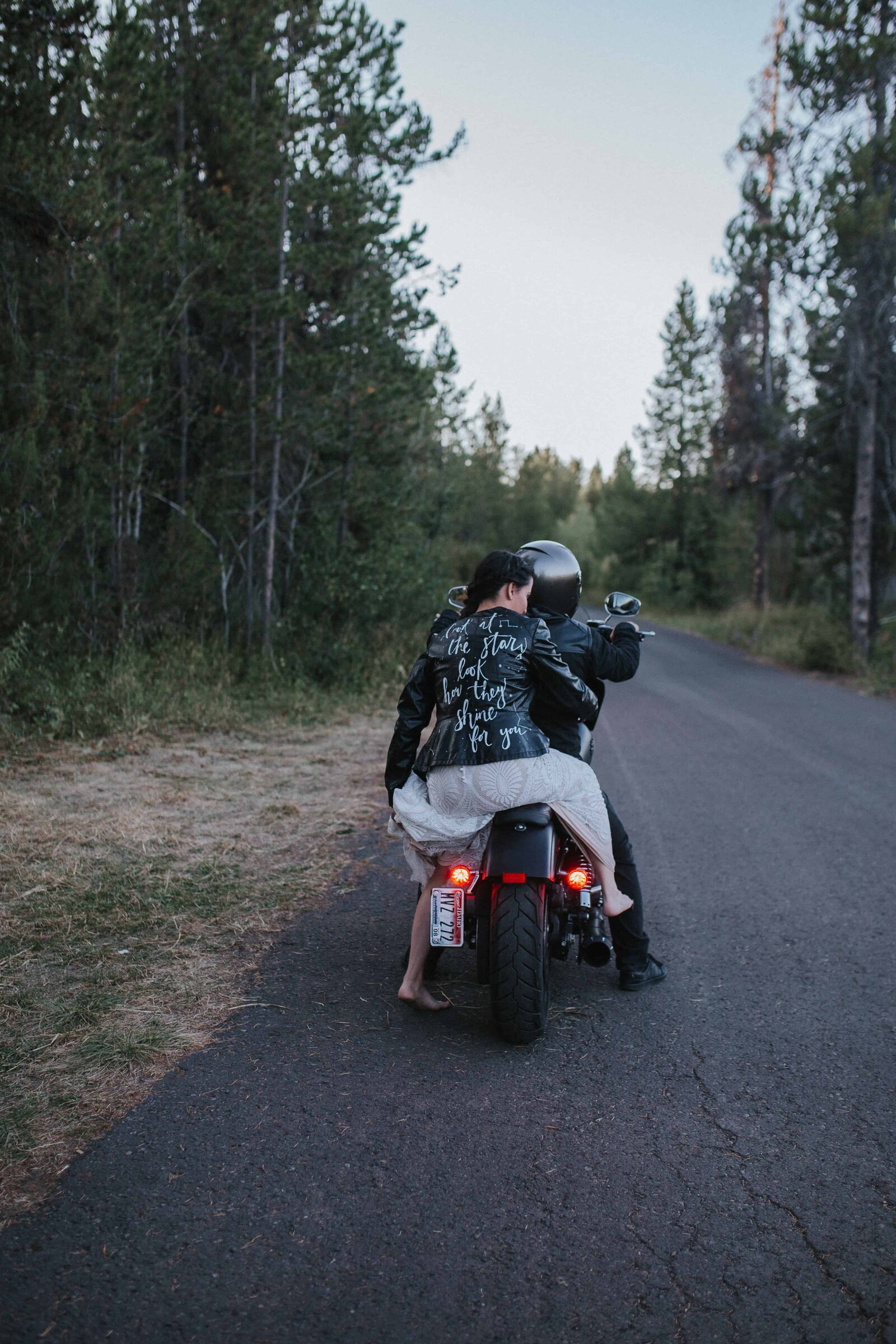 Nashville bride and groom riding away from their dreamy nashville wedding venue on a motorcycle