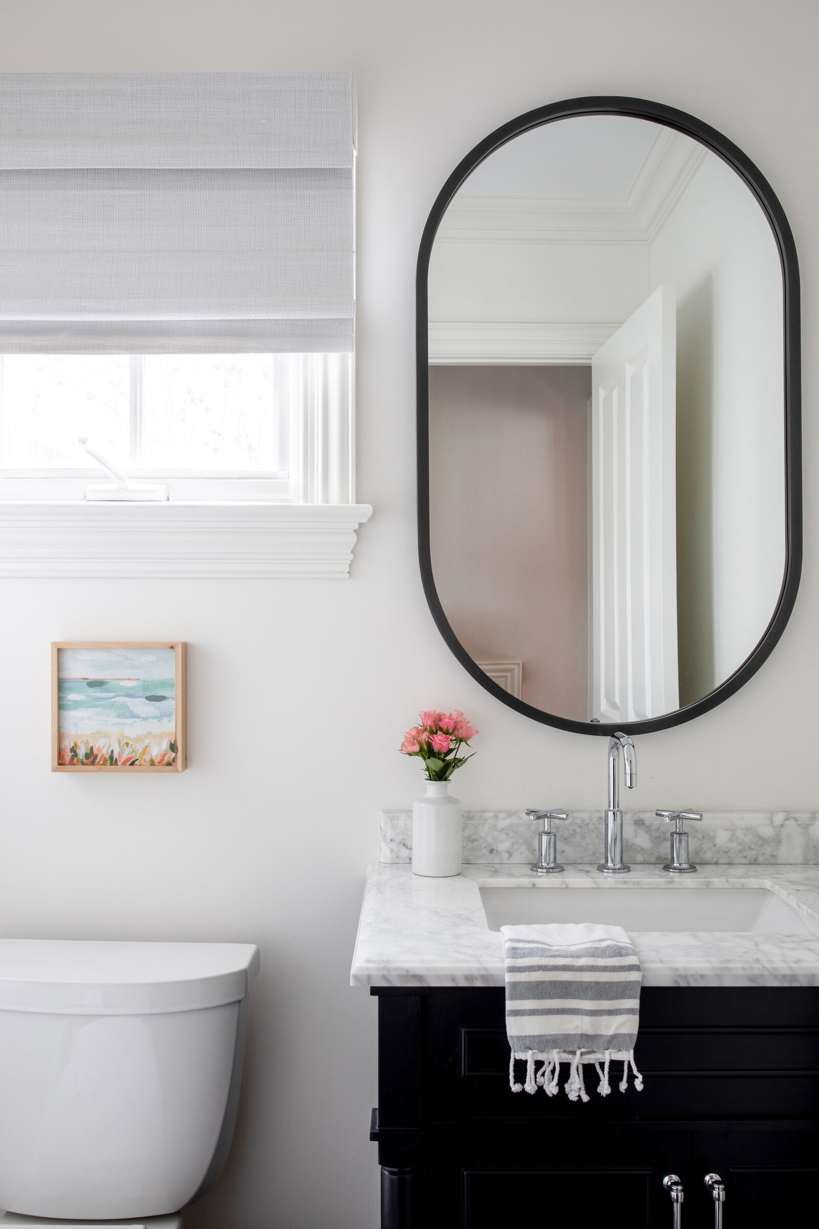 POWDER-ROOM-WITH-OVAL-MIRROR-AND-MARBLE-TOP